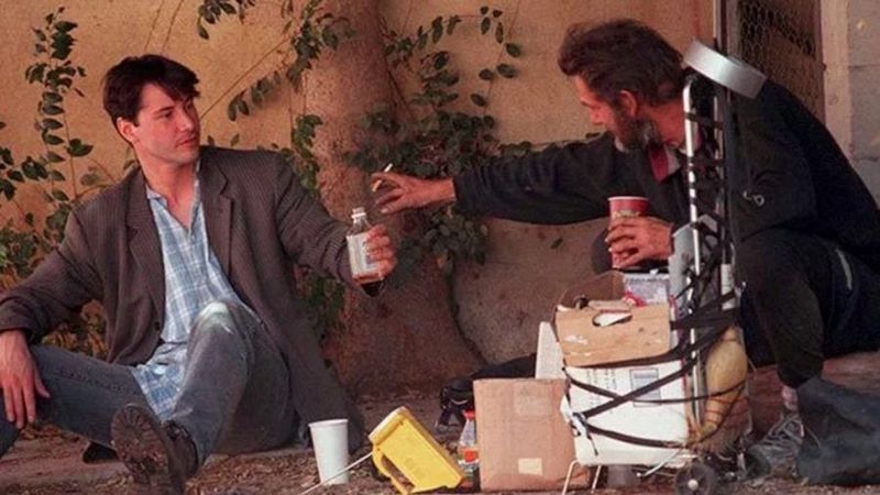 Keanu Reeves sharing a meal with a homeless man