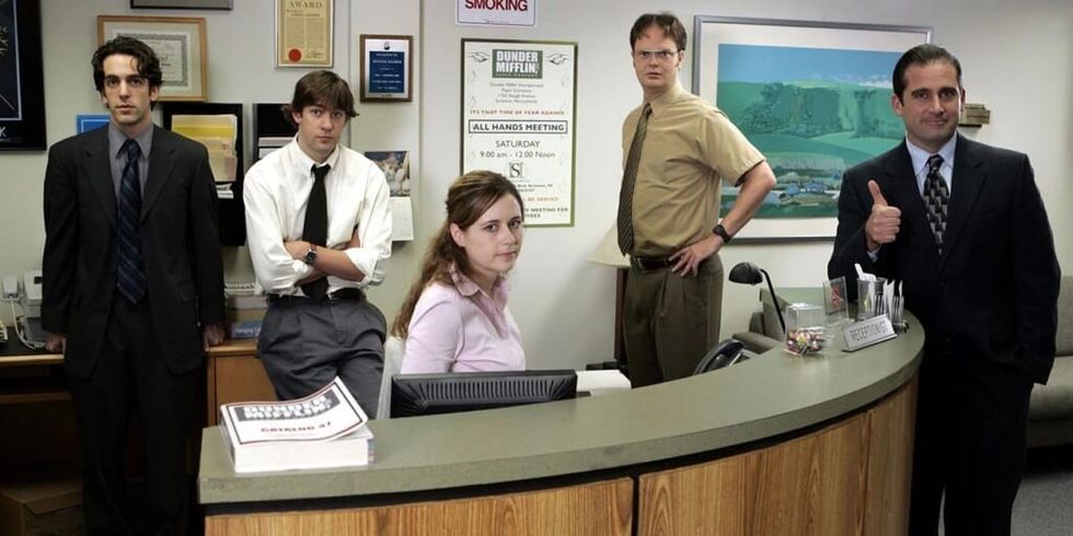 Cast of The Office standing near Pam's desk